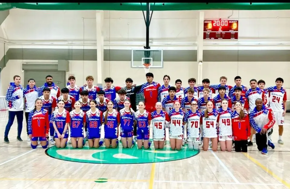 image-1 Basketball teams posing in a gymnasium.